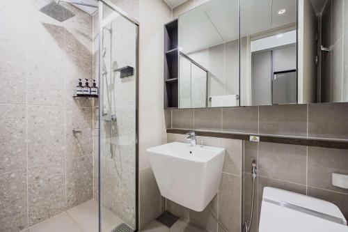 a bathroom with a toilet and a sink and a shower at Odays Osiria Residence in Busan