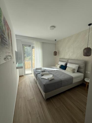 a large bedroom with two beds and a window at Villa Casa Solea in Myrthios