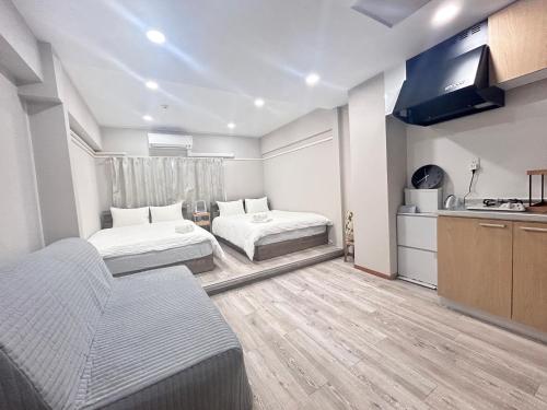 a hotel room with two beds and a kitchen at Y-Shinjuku City, Okubo 3F-SJ0069 in Tokyo