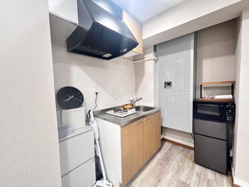a small kitchen with a sink and a refrigerator at Y-Shinjuku City, Okubo 3F-SJ0069 in Tokyo
