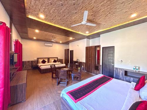 a bedroom with a bed and a living room at DLS MJ River Resort, Rishikesh in Shivpuri