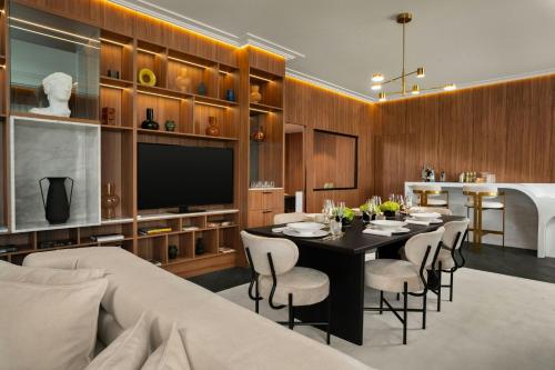 a dining room with a table and chairs and a television at Cardo Roma, Autograph Collection in Rome