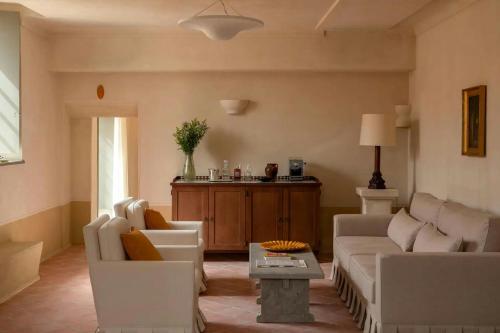 a living room with two white couches and a table at Hôtel du Couvent, a Luxury Collection Hotel, Nice in Nice