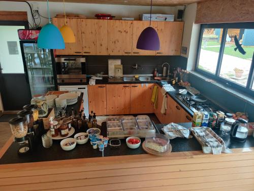 a kitchen with a counter with bottles and food on it at Glamping Virje in Bovec