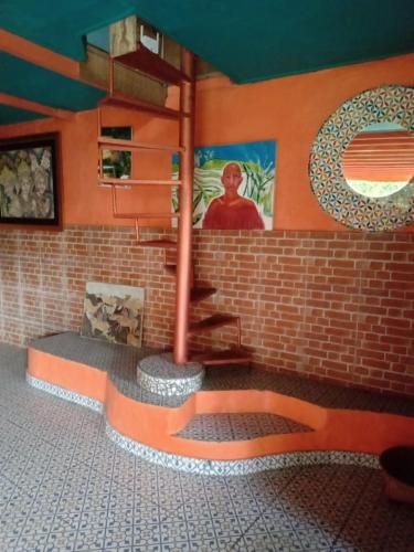 a room with a brick wall and a staircase in a building at Ubud Jungle River in Ubud