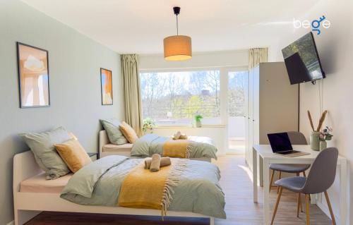 a bedroom with two beds and a couch and a table at BEGE APARTMENTS BizConnect in Wuppertal