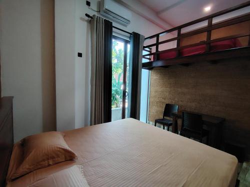 a bedroom with a large bed and a large window at Star Guest in Balangoda