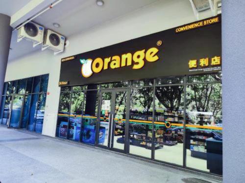 a orange sign on the front of a store at JQ Premier Suites T1 L07 - KK TOWN in Kota Kinabalu