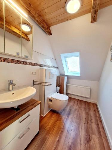 a bathroom with a white sink and a toilet at Ferienhaus im Koog in Tetenbüll