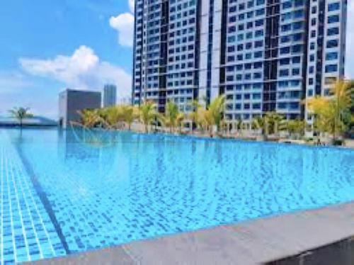 a large swimming pool in a city with tall buildings at JQ Premier Suites T1 L07 - KK TOWN in Kota Kinabalu