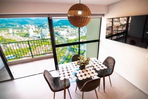 a dining room with a table and chairs and a large window at Cosy Mountain View 3BR Apartment, Prime Location! in Floridablanca