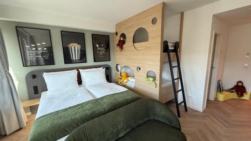 a bedroom with a bed and a ladder in it at Cinema City Hotel Europaplatz Karlsruhe - Brand New Boutique Hotel 2025 - in Karlsruhe