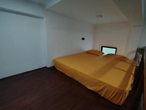 a bedroom with a bed in a white room at Star Guest in Balangoda