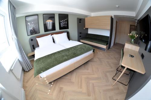a small bedroom with a large bed and a staircase at Cinema City Hotel Europaplatz Karlsruhe - Brand New Boutique Hotel 2025 - in Karlsruhe