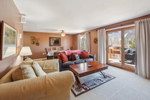 a living room with a couch and a table at Hawkeye 21E - Spacious Townhome for Families in North Creek