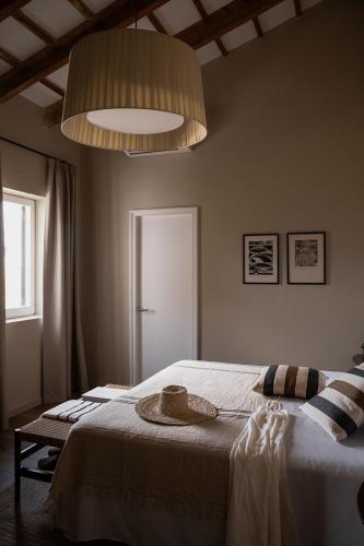 a bedroom with a bed and a large light at Binissaida Boutique Hotel in Es Castell