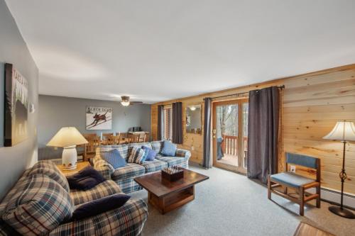 a living room with two couches and a table at Cloud 50G - The Ultimate Adirondack Experience in North Creek