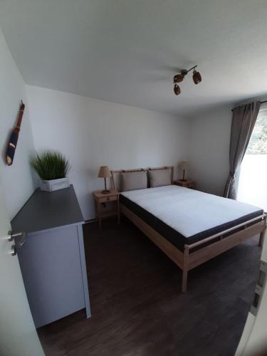 a bedroom with a large bed and a desk at Küstenwind in Graal-Müritz