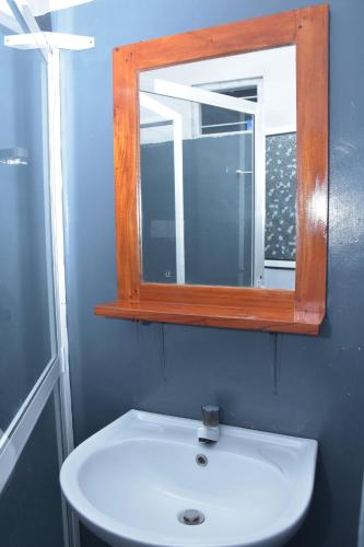 a bathroom with a mirror and a white sink at Coastal Heaven Villa in Trincomalee