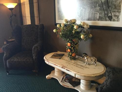 a table with a vase with a zebra on it at The Flying Trout Boutique Lodge in Taupo