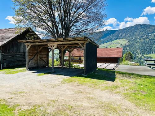 a wooden pavilion in front of a building at Apartment Oberleins II in Arzl im Pitztal