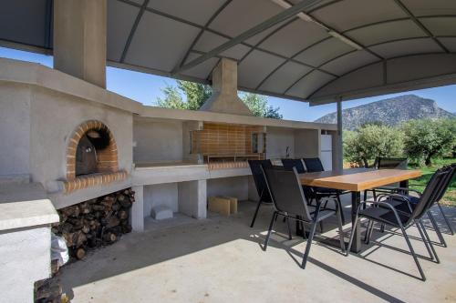 an outdoor patio with a table and a pizza oven at Sweet Sissi Homes in Sissi