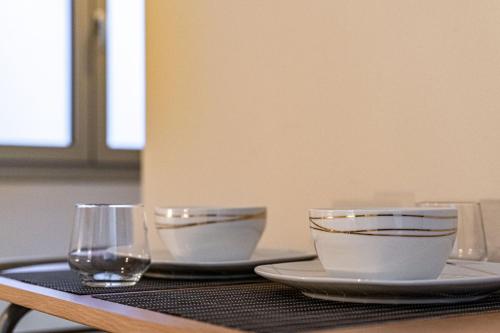 a table with two bowls and a glass on it at Residenza Grazioli 2 in Verona