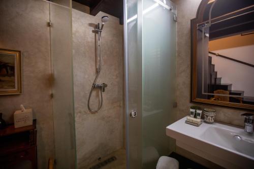 a bathroom with a glass shower and a sink at Dar Lalzohra in Rabat