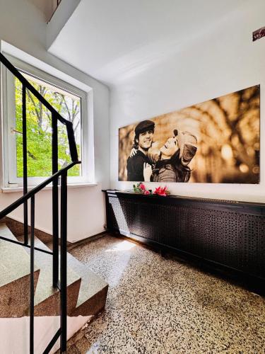 a painting of a couple on a wall in a room at Spacious 6BR Shared Villa with Garden near Danube For 16 Guests in Vienna