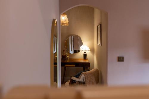 a room with a desk and a mirror at The Beach House Boutique Hotel in Sunderland