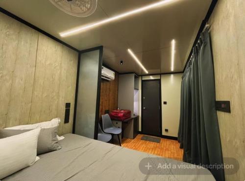 a bedroom with a bed and a desk with a chair at Natural Lake Pawna in Lonavala