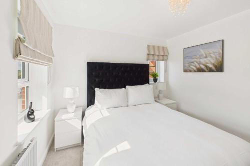 a white bedroom with a white bed and a window at Host & Stay - Orient House in Yarm