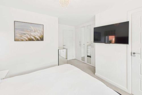 a white bedroom with a bed and a mirror at Host & Stay - Orient House in Yarm