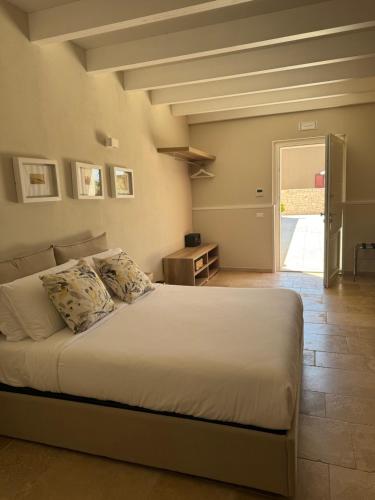 a bedroom with a bed and a door to a patio at Villa Brigida Resort in Santeramo in Colle