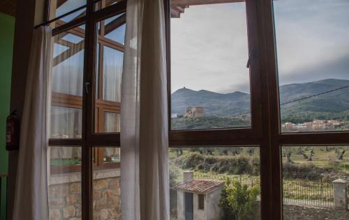 a window with a view of a mountain view at Casa Rural La Flor del Naranjo in Cadalso