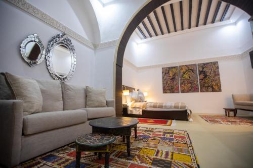 a living room with a couch and a bed at Dar Lalzohra in Rabat