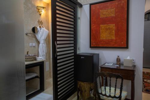 a room with a chair and a table and a piano keyboard at Dar Lalzohra in Rabat
