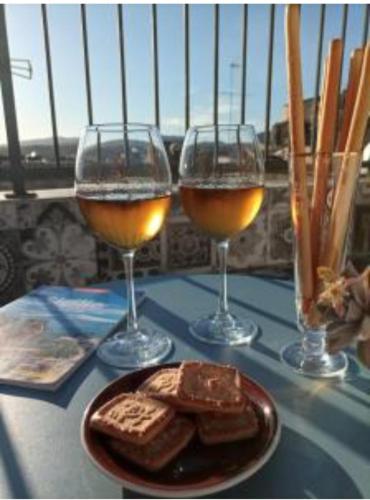 three glasses of wine and bread on a table at Casa Matea in Noto