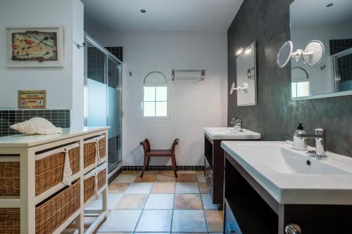 a bathroom with a sink and a tub and a mirror at Villa Alba in Santa Eularia des Riu