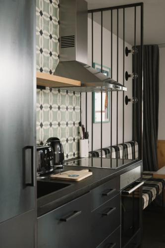 a kitchen with a black counter top and a stove at Schönherr Haus in Neustift im Stubaital
