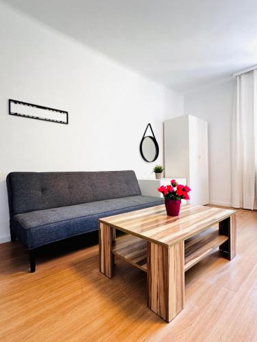 a living room with a couch and a coffee table at Spacious 6BR Shared Villa with Garden near Danube For 16 Guests in Vienna