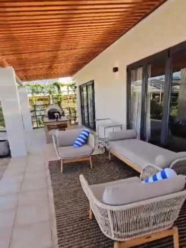 a living room with couches and chairs and a fireplace at Ochre and Ash in Clanwilliam