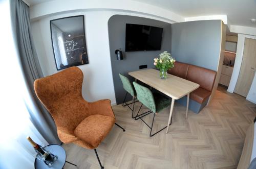 a small dining room with a table and chairs at Cinema City Hotel Europaplatz Karlsruhe - Brand New Boutique Hotel 2025 - in Karlsruhe