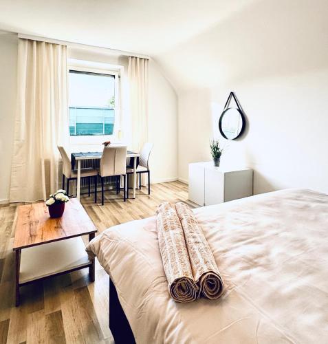 a bedroom with a bed and a table and a dining room at Spacious 6BR Shared Villa with Garden near Danube For 16 Guests in Vienna