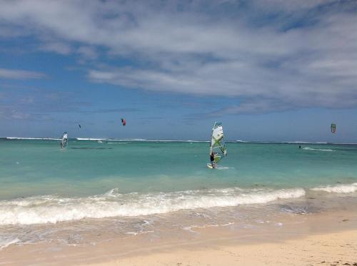 a person in the water with a sail in the ocean at 76 Morc La Fleche in Midlands Station
