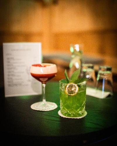 a table with a drink and a glass on it at Hotel Hofgut Sternen - Ravennaschlucht in Breitnau