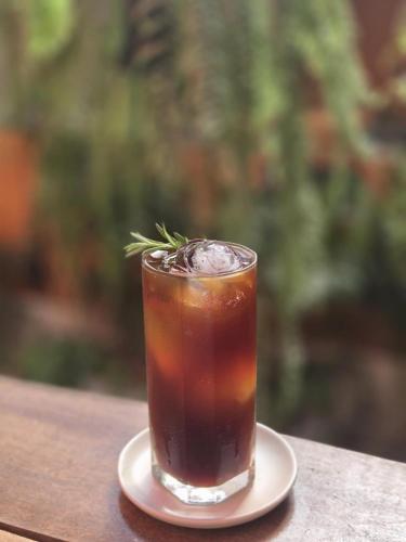 a drink on a plate on a table at Vonden Garden by Merry V in Bangkok