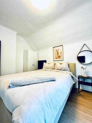a bedroom with a large white bed with a lamp at Spacious 6BR Shared Villa with Garden near Danube For 16 Guests in Vienna