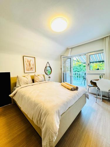a bedroom with a large bed and a table at Spacious 6BR Shared Villa with Garden near Danube For 16 Guests in Vienna