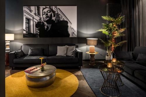a living room with a couch and a coffee table at Hotel AMANO Düsseldorf in Düsseldorf